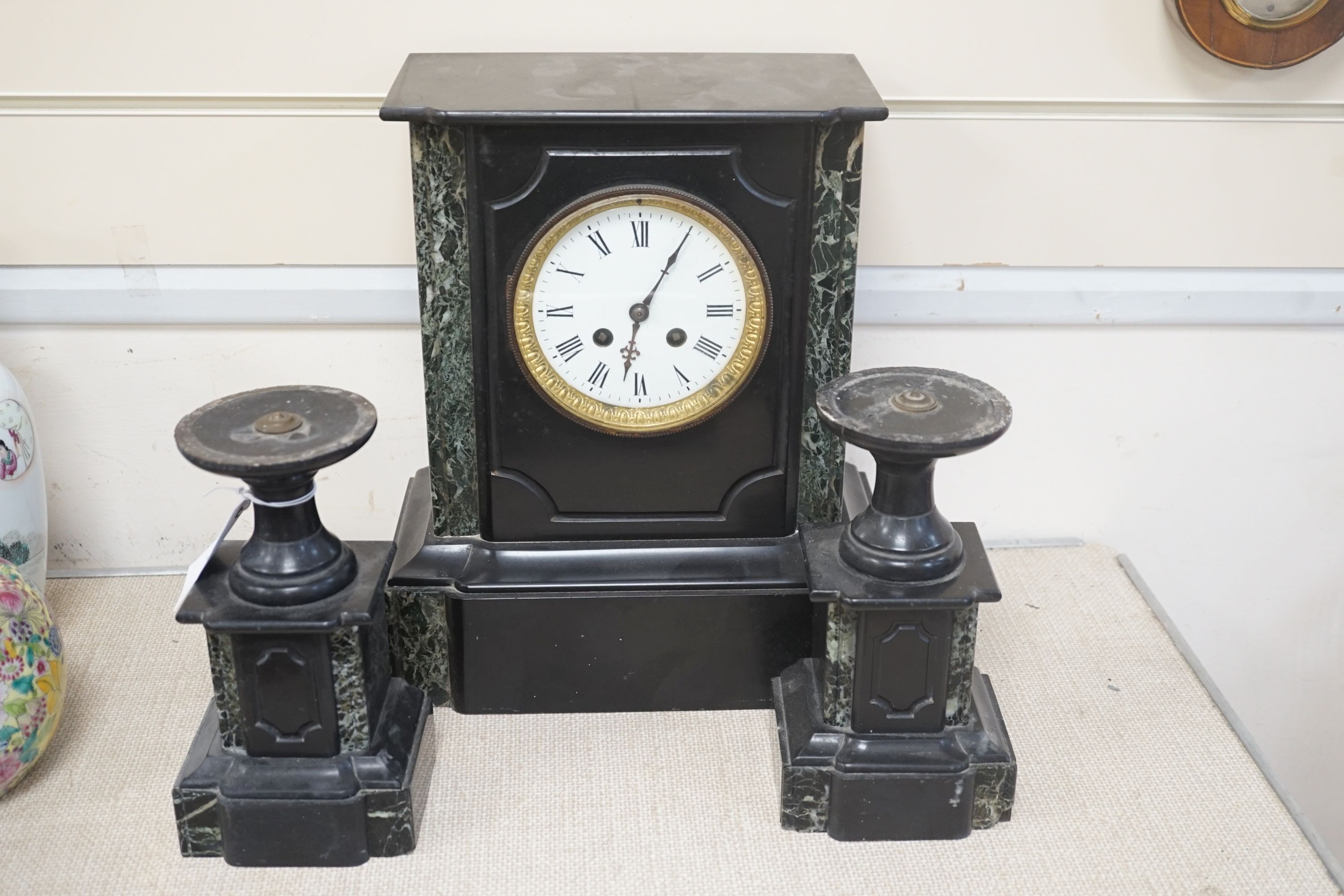 A Victorian black slate clock garniture